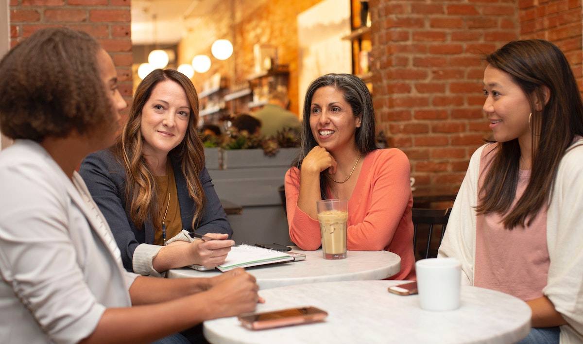 four job seekers discussing how to write a CV/resume