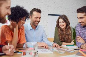 Happy, smiling employing looking at plans as high performing employees